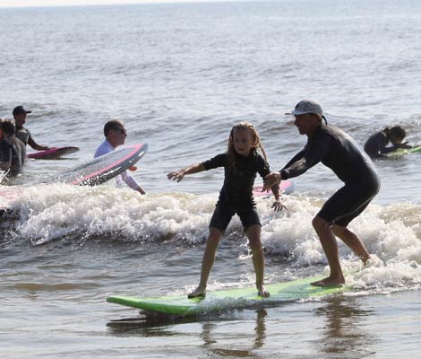 Surfboard being sanded during ding repair